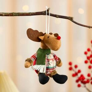 Detail of plush Christmas reindeer ornament with plaid fabric and wood buttons on tree