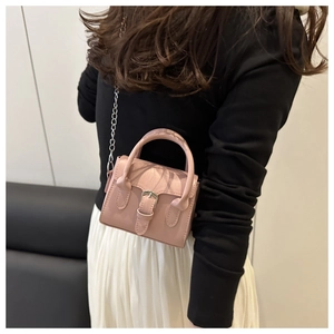 Pink mini square bag featuring decorative silver buckle and detachable chain strap shown on model