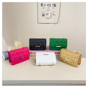 Detail view of quilted chain bags in five colors including pink, green and blue shades