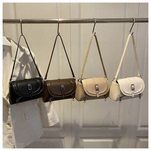Detailed row of vintage leather baguette bags in black, brown, khaki and white finishes