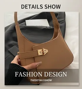 Detail of khaki leather shoulder bag with gold metal buckle and sleek urban texture