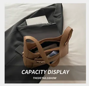 Interior view of tan pebble leather shoulder bag showing capacity for daily essentials