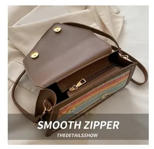 Detailed interior view showing smooth zipper, magnetic clasp and colorful woven pattern