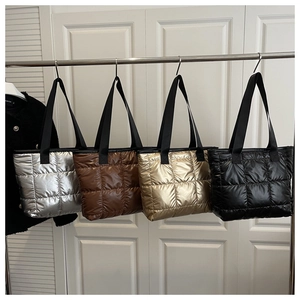 Detailed display of quilted tote bags in silver, brown, gold and black metallic finishes