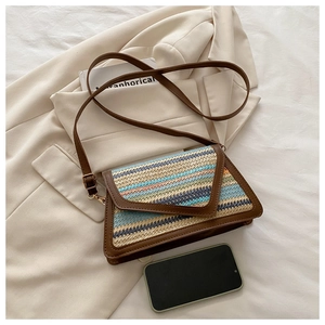 Detailed view of the woven rectangular crossbody bag with blue and orange stripes