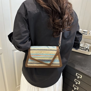 Minimalist woven straw crossbody bag with colorful stripes and brown leather trim