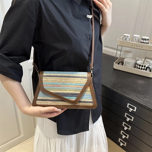 Multicolor striped woven crossbody bag with brown faux leather trim and envelope closure