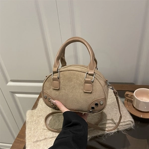 Retro suede and leather patchwork handbag with metallic rivets and top handle
