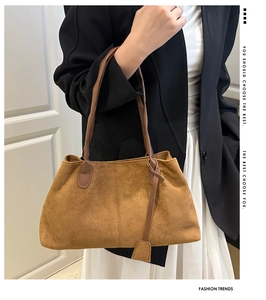 Brown matte suede tote bag styled with black blazer and white pleated skirt for work
