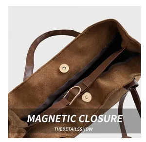 Detail of light gold magnetic closure and corduroy texture on brown tote bag