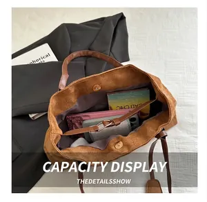Detailed interior of brown corduroy tote bag showing large capacity with magnetic closure