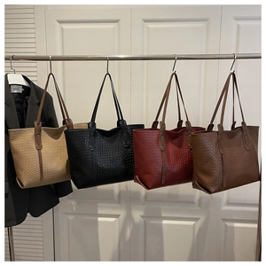 Detail view of woven tote bags in beige, black, burgundy, and coffee with textured patterns
