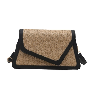 Minimalist woven straw square bag with black leather trim and asymmetric flap cover