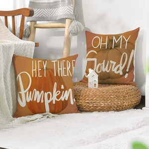 Set of two linen autumn pillow covers featuring pumpkin designs and festive typography