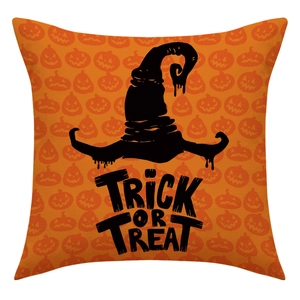 Detail of linen Halloween pillow cover with orange pumpkin pattern and witch hat print