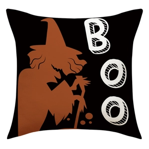 Detail of Halloween linen pillowcase featuring a black wizard silhouette and BOO lettering