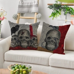 Gothic skull and raven Halloween linen pillow covers set displayed on a modern white sofa