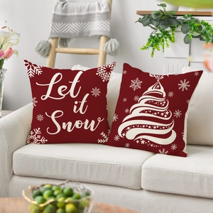Red Christmas pillow covers set with Let it Snow and tree patterns on a beige sofa