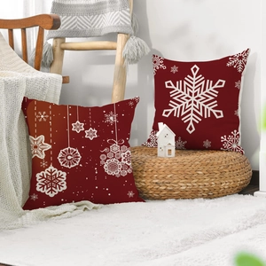 Detail of red Christmas pillow covers with white snowflake patterns on linen fabric