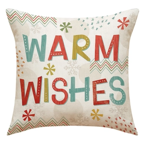 Macro detail of Warm Wishes print and coarse linen texture on Christmas pillow cover