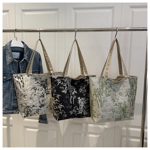 Detailed view of canvas tote bags with elegant bamboo leaf prints in three colors