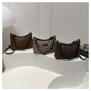 Detailed display of three leopard print hobo bags in brown, beige, and dark coffee colors