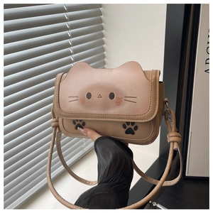 Detail of cute cat shaped crossbody bag with ear outlines and paw prints on PU leather