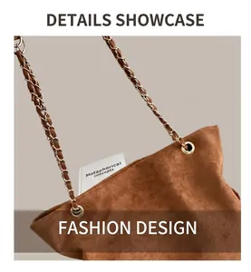 Close-up of brown suede shoulder bag with gold metal chain and leather woven strap