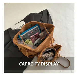Brown suede bucket tote and small crossbody set showcasing spacious interior capacity