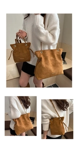 Detail view of brown suede bucket bags with gold chain straps and fashion logo