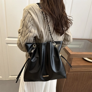 Black PU leather drawstring bucket bag with gold chain strap and fashion logo