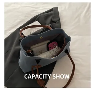 Detailed interior of blue canvas tote bag showing large capacity and magnetic closure
