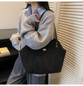 Chic black matte tote bag with gold swivel lock closure and long shoulder straps