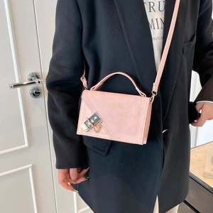 Pink minimalist chain crossbody bag with gold hardware and small square flap design
