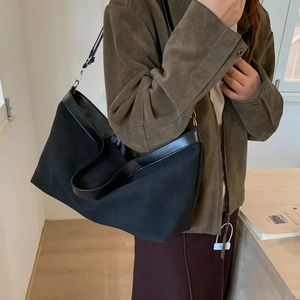 Large black frosted tote bag with adjustable leather strap in a crescent shape design