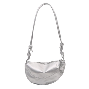 Metallic silver crescent shoulder bag with knot details and adjustable strap on white background