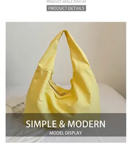 Nahaufnahme der gelben Nylon-Schultertasche mit Metallreißverschluss und breitem Gurt