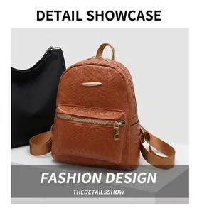 Detail of brown woven PU leather backpack featuring golden zipper and metal hardware