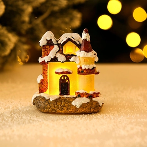 Luminous resin Christmas house ornament with warm LED lights and snowy details