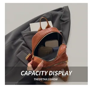 Detailed internal view of mini brown woven backpack showing capacity for phone and wallet