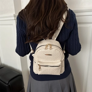 Mini cream woven leather backpack for women with gold zippers and adjustable straps