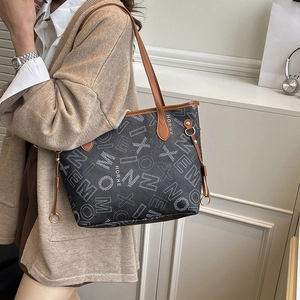 Large tote bag with geometric print and brown leather handles for autumn fashion