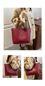 Detail of burgundy pebbled leather tote bag with metallic buckle and shoulder strap