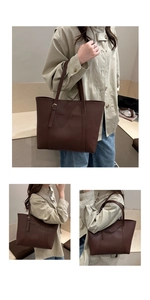 Detail of a dark brown large tote bag showing stitching and metal adjustment buckle