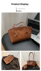 Detail of vintage brown tote bag with knot decor, internal pouch and leather texture