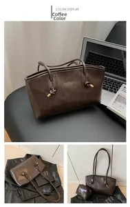 Detail of dark brown vintage PU leather tote bag with knotted handles and matching pouch