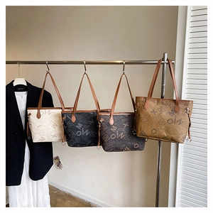 Detail showing high-capacity monogram tote bags in white, black, dark coffee and brown