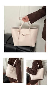 Detail of off-white PU leather tote bag with functional outer pocket and metal buckles