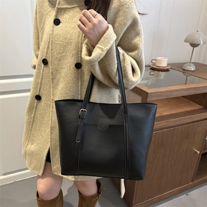 Black large capacity faux leather tote bag with adjustable gold buckle and front pocket