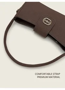 Close-up of the vintage matte shoulder bag featuring a golden metal horsebit buckle detail